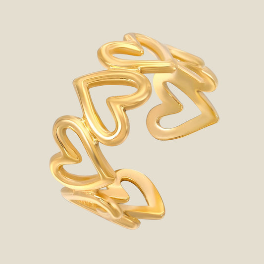 Anillo de corazones dorados para mujer. Diseño moderno, romántico y ajustable. Perfecto como regalo o para añadir un toque dulce al look.